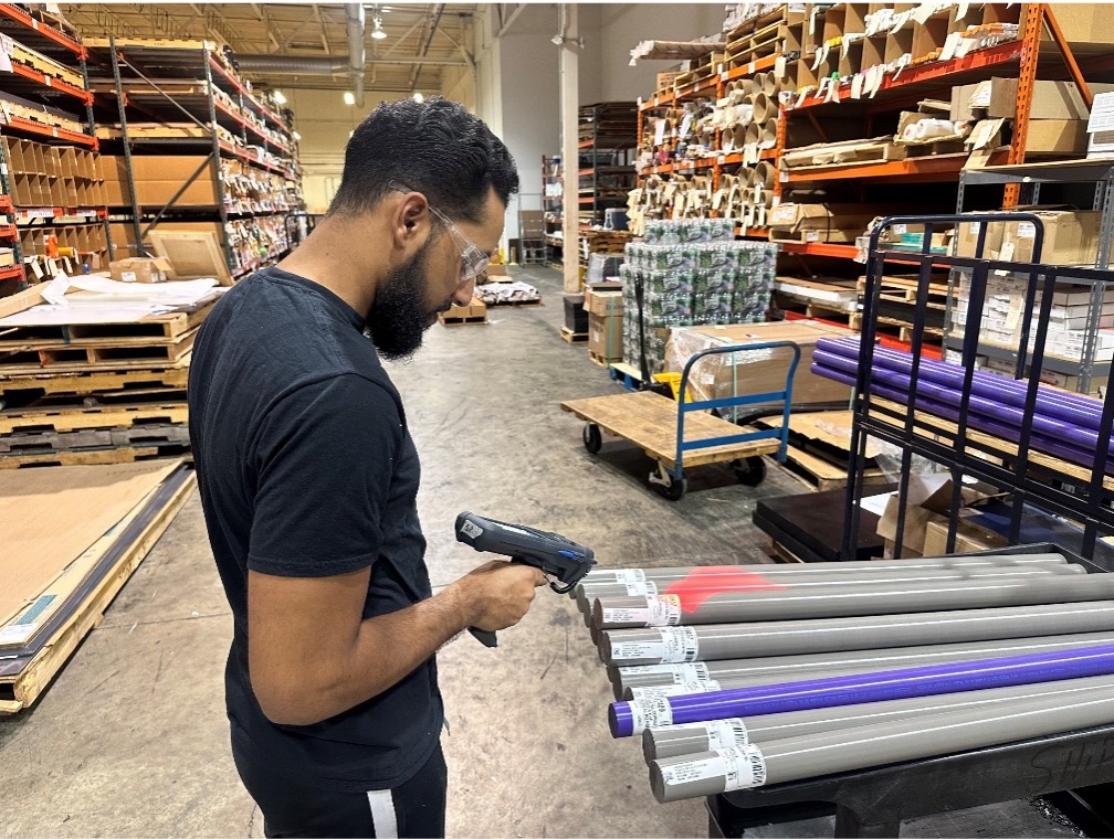 Warehouse inventory control — Shelton, CT Modern Plastics warehouse team member scanning inventory for order fulfillment in Shelton, CT.